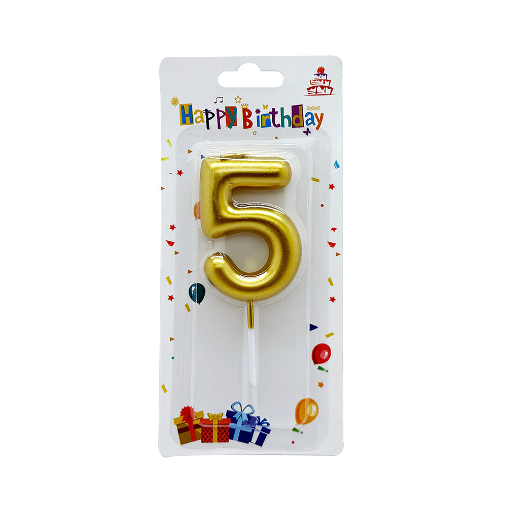 Assorted cake decorations on a creamy background, including striped birthday candles, a gold number 4 candle, and gold star and heart-shaped toppers.