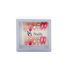 Fake Nail(YY25) set displayed in a clear box featuring various colorful designs and nail art.