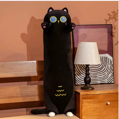 Plush Black Cat 70CM standing next to a table lamp in a cozy room setting.