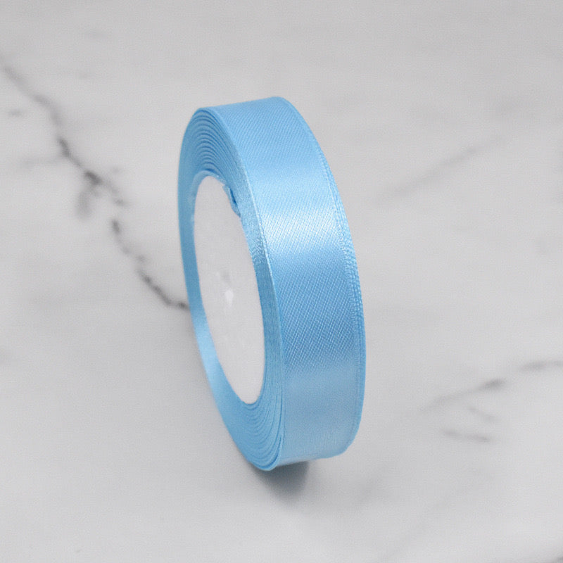 🧵 Premium Satin Ribbon – Versatile & Elegant in soft blue color, perfect for gift wrapping and craft projects.