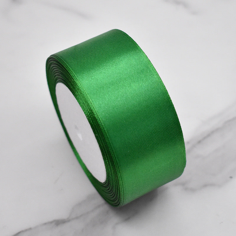 🧵 Premium Satin Ribbon – Versatile & Elegant in vibrant green color on a marble surface.