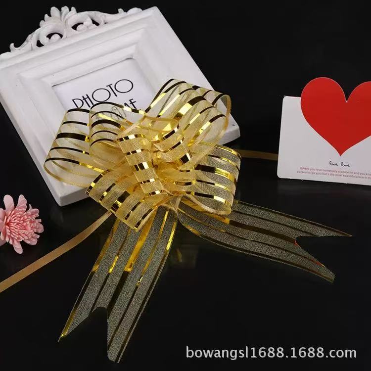Pulling Ribbon(10PCS/3*47CM) decorative bow with gold stripes on a black background