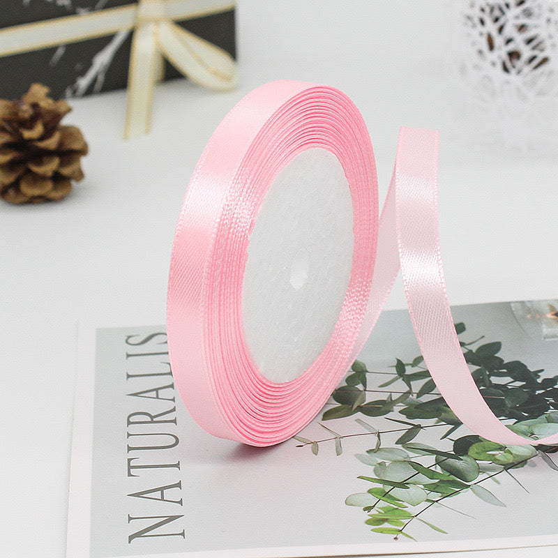 🧵 Premium Satin Ribbon – Versatile & Elegant, soft pink color on a spool, ideal for gift wrapping and crafts.